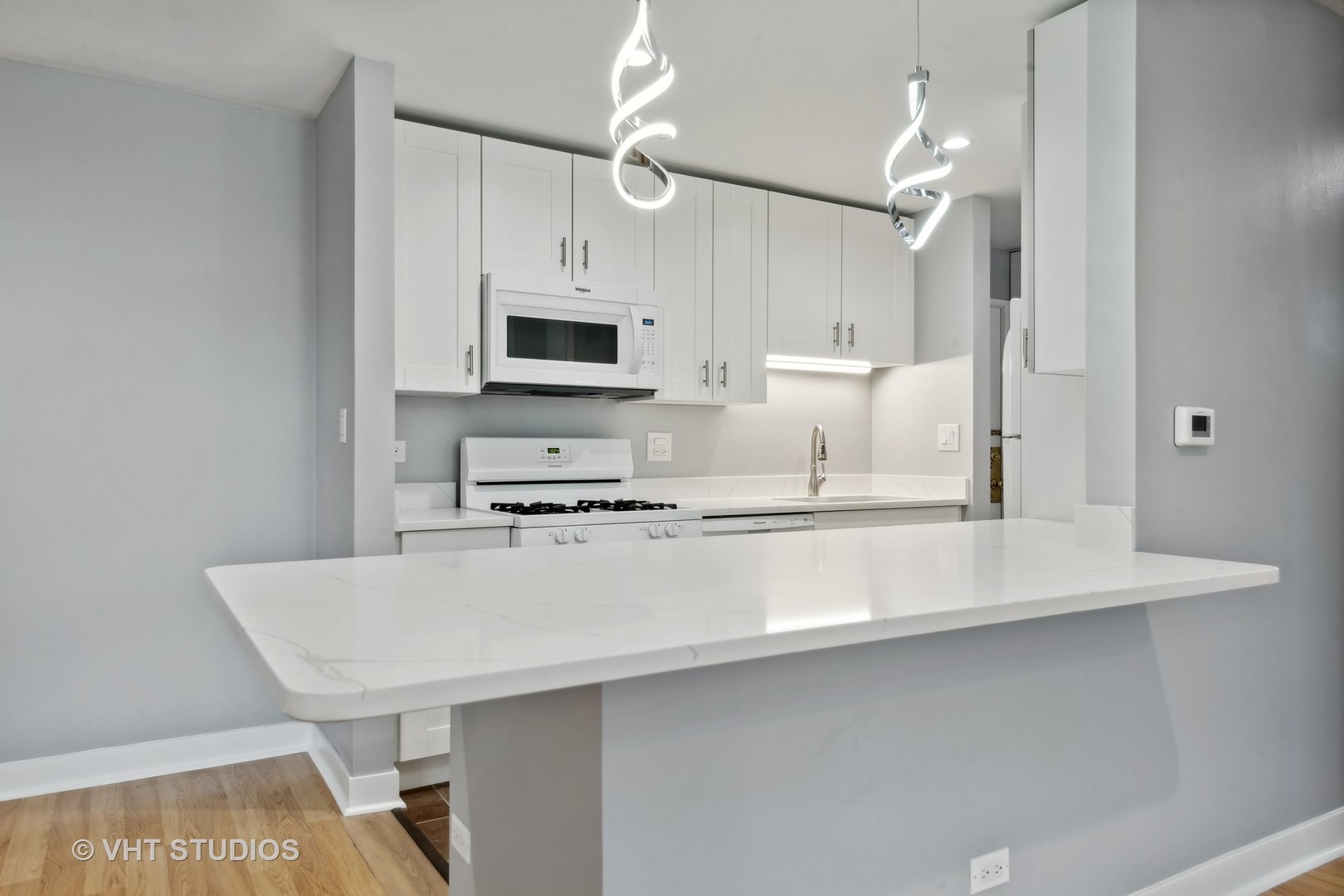 1107 South Old Wilke Road, Unit 205 Rolling Meadows, IL 60008 - Photo 6 of 19 a kitchen with appliances a sink cabinets and wooden floor