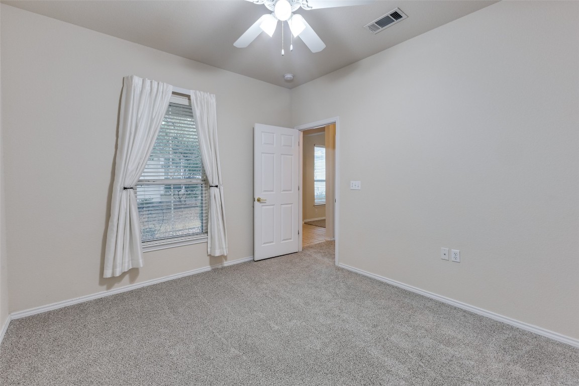 206 Bonham Loop Georgetown, TX 78633 - Photo 13 of 18 an empty room with chandelier fan and windows