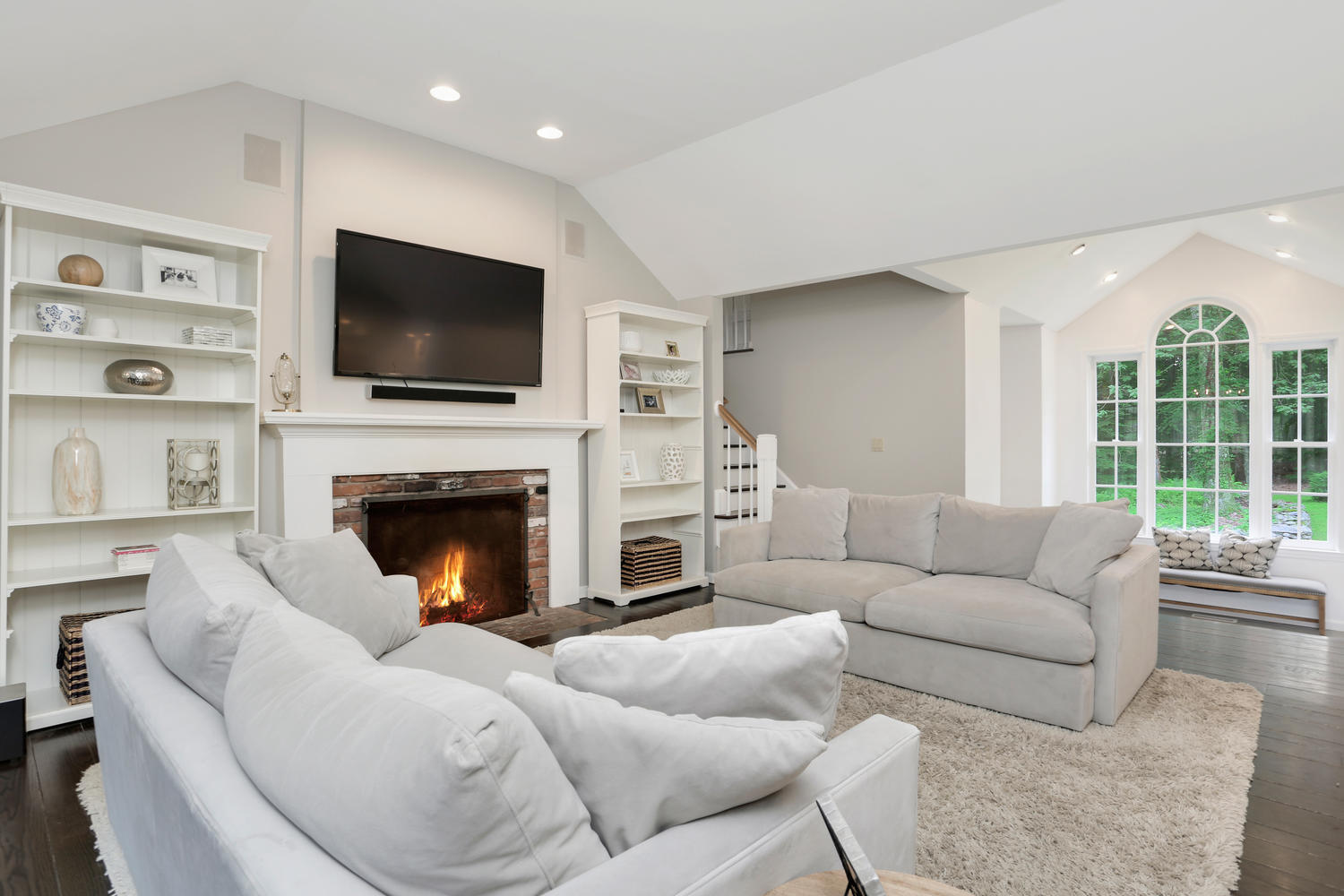 171 Jonathan Road New Canaan, CT 06840 - Photo 17 of 38 a living room with furniture a fireplace and a flat screen tv