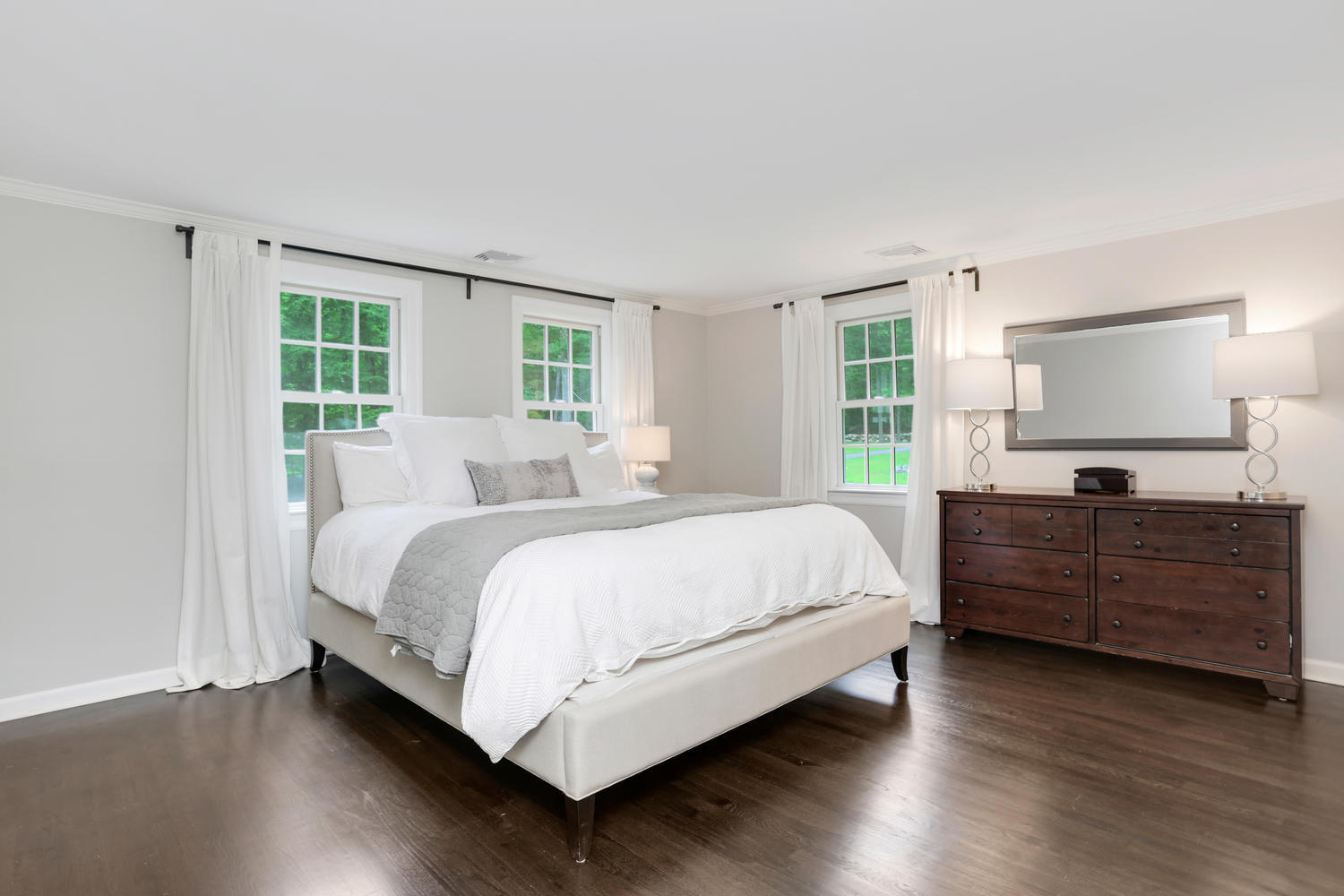 171 Jonathan Road New Canaan, CT 06840 - Photo 22 of 38 a large bed sitting in a bedroom next to a window and dresser