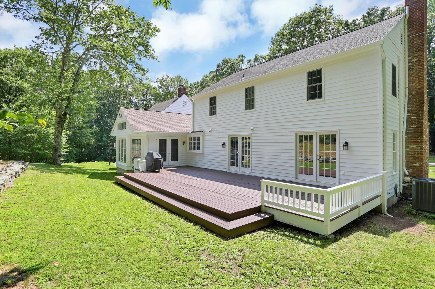 171 Jonathan Road New Canaan, CT 06840 - Photo 33 of 38 a view of a house with a backyard and deck
