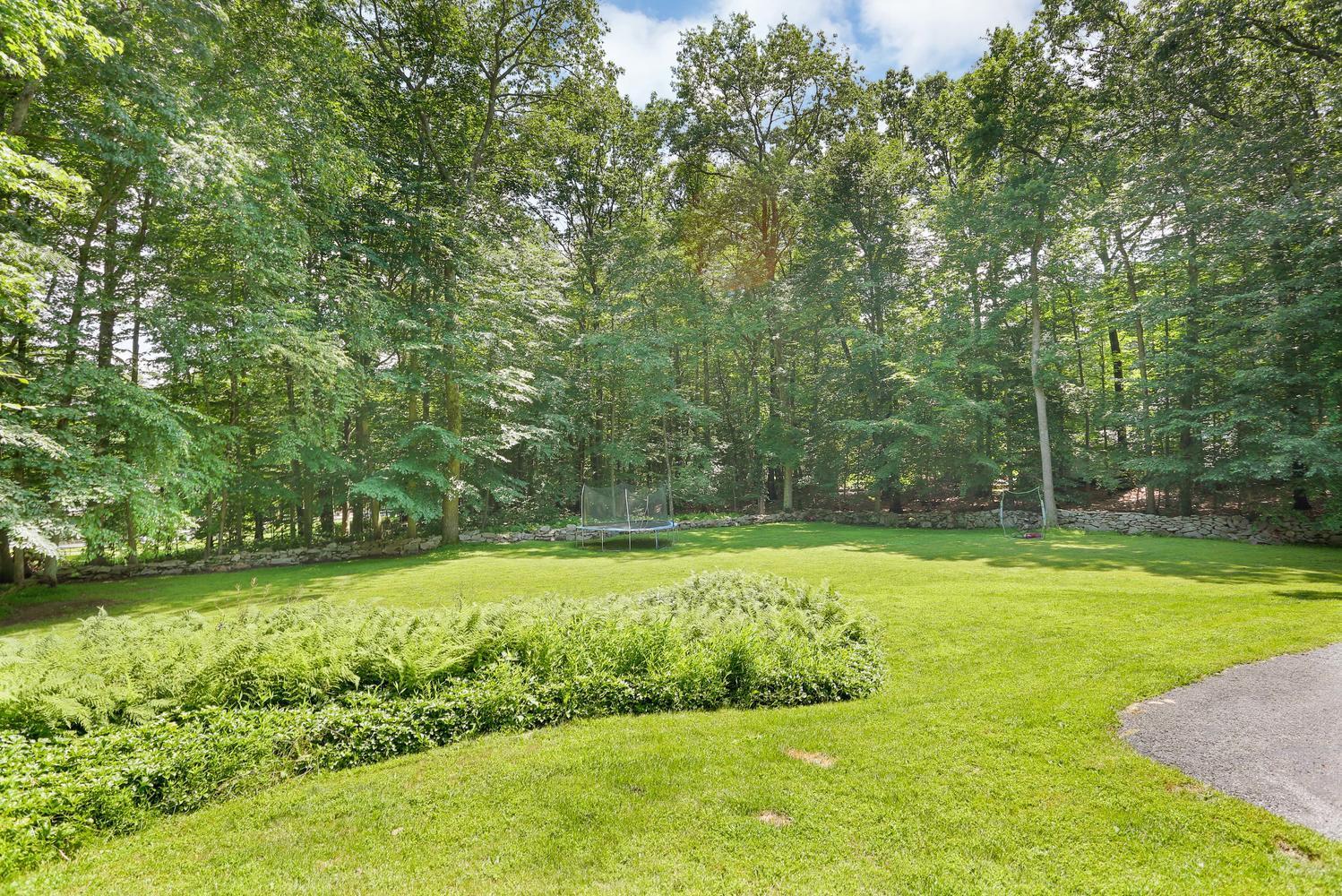 171 Jonathan Road New Canaan, CT 06840 - Photo 36 of 38 a view of a backyard with swimming pool