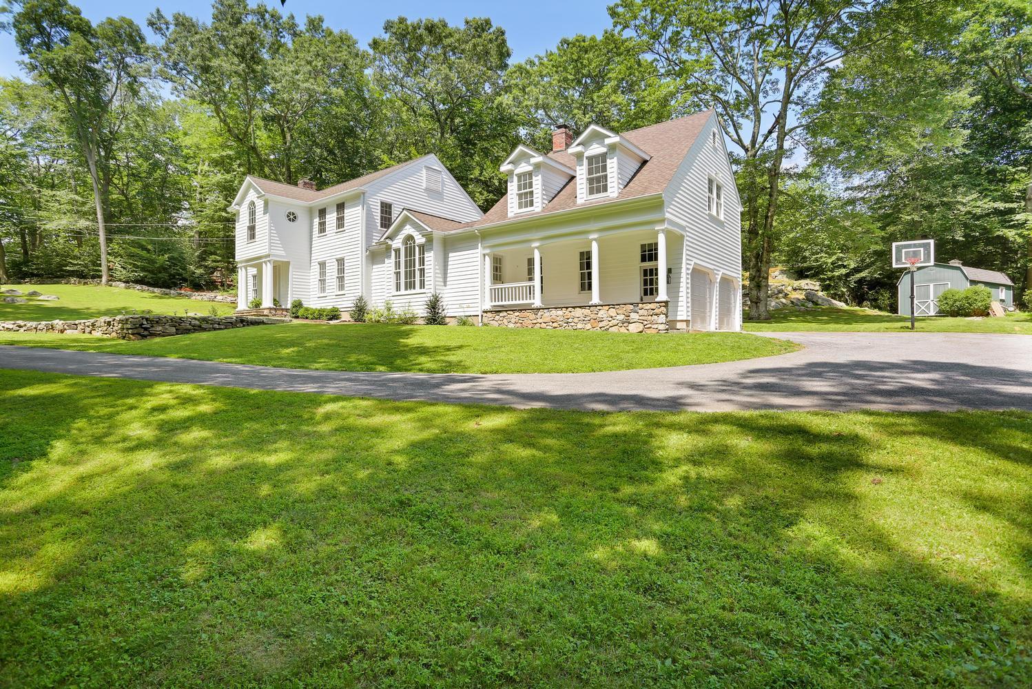 171 Jonathan Road New Canaan, CT 06840 - Photo 38 of 38 a front view of a house with a yard and green space