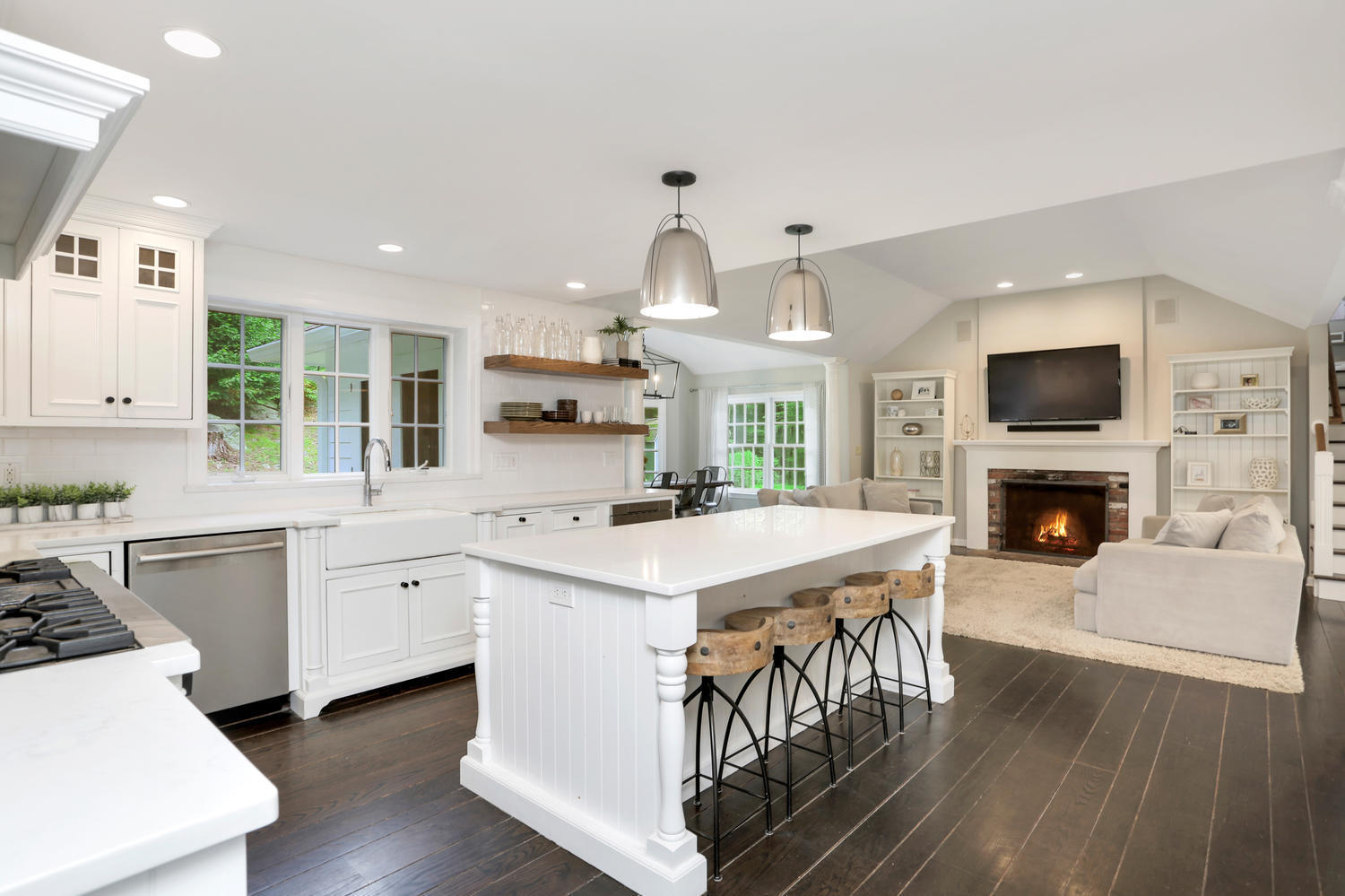171 Jonathan Road New Canaan, CT 06840 - Photo 8 of 38 a kitchen with a stove top oven a sink dishwasher and a fireplace with wooden floor