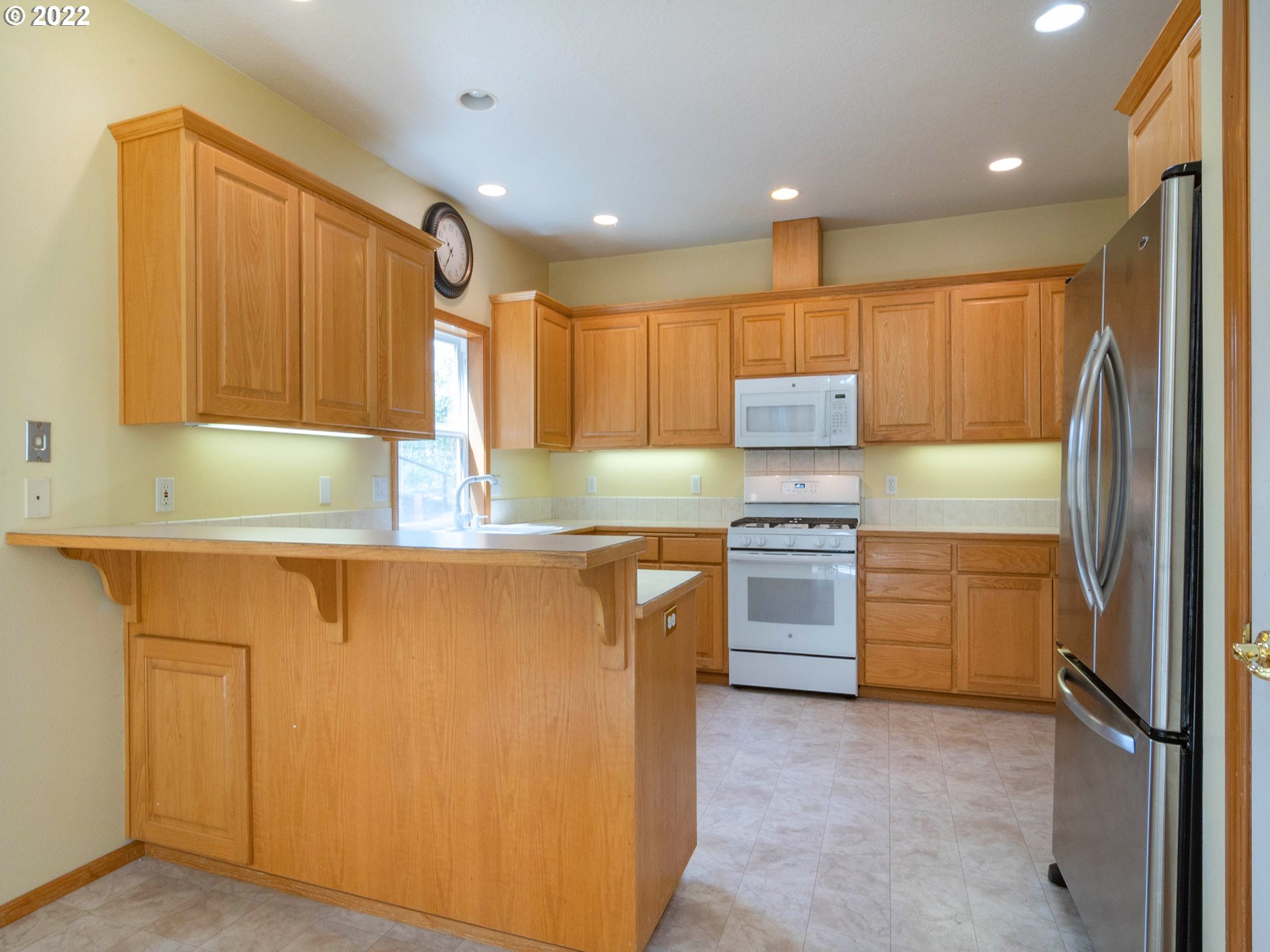 2255 33rd Street Springfield, OR 97477 - Photo 13 of 31 a kitchen with a refrigerator sink and cabinets