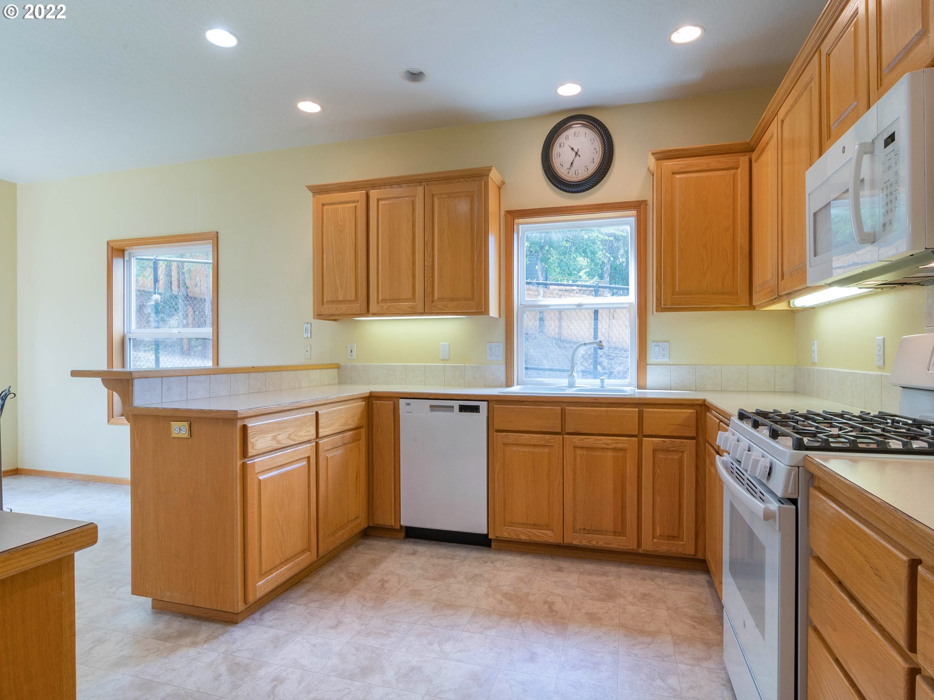 2255 33rd Street Springfield, OR 97477 - Photo 10 of 31 a kitchen with granite countertop a stove a sink and a cabinets
