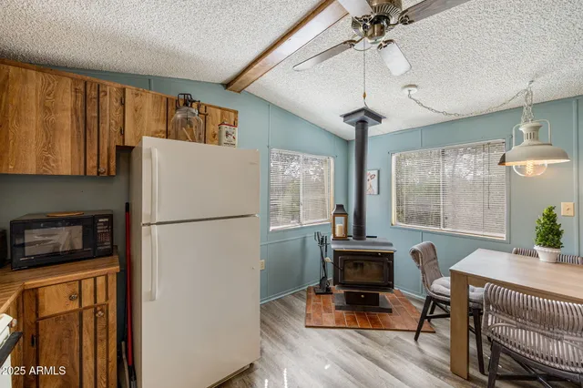 a dining room with furniture a chandelier and wooden floor
