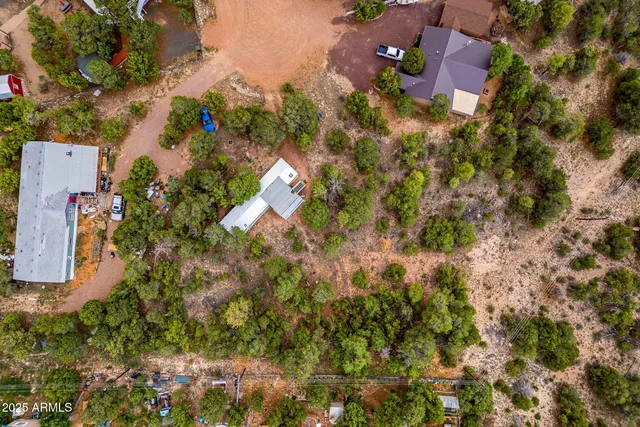 an aerial view of a house with a yard and garden