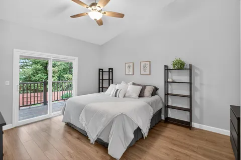 a large bedroom with a bed and a large window