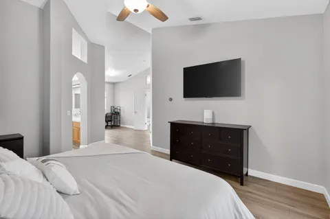 a bedroom with a bed and a flat screen tv