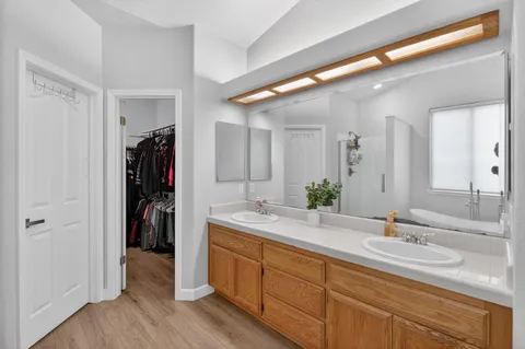 a bathroom with a double vanity sink and a mirror