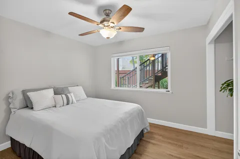 a bedroom with a large bed and a window