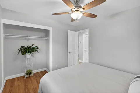 a bedroom with a bed and a potted plant
