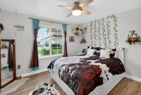 a bed sitting in a bedroom next to a window