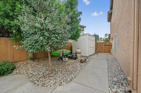 a backyard of a house with table and chairs