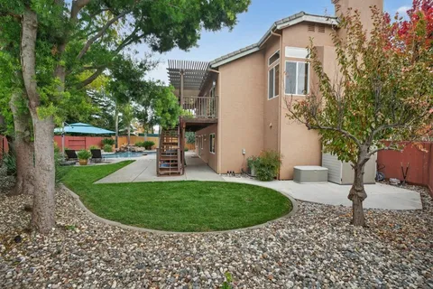 a view of a house with a backyard