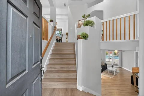 a view of entryway and hall with wooden floor