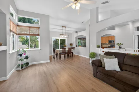 a living room with furniture and wooden floor