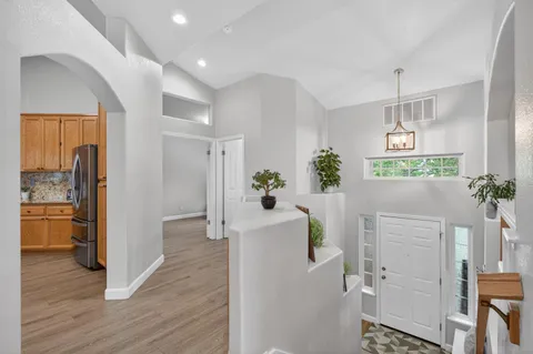 a hallway with a dining table and chairs