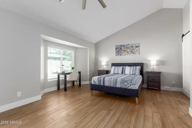 a bedroom with a bed and a table in it