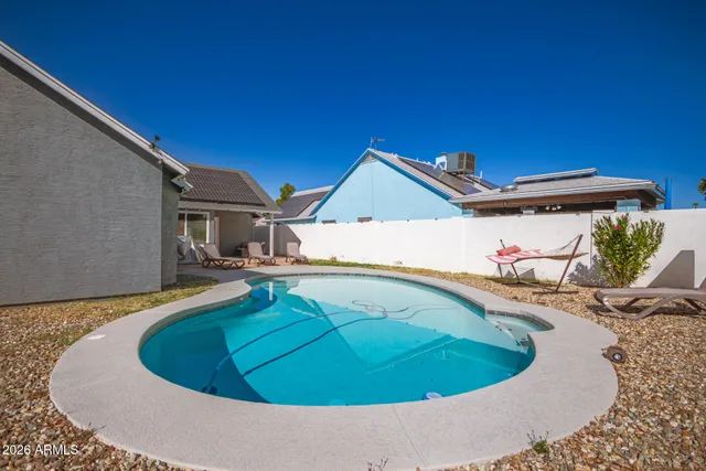 a small pool with trees in the background