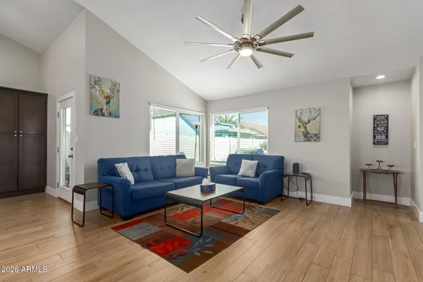 a living room with furniture and a wooden floor
