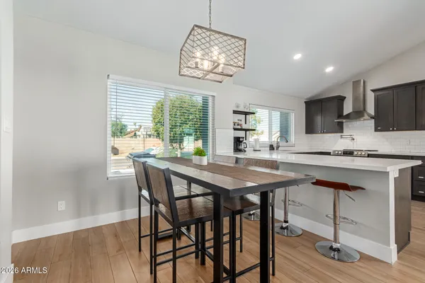 a dining room with a table chairs and chandelier