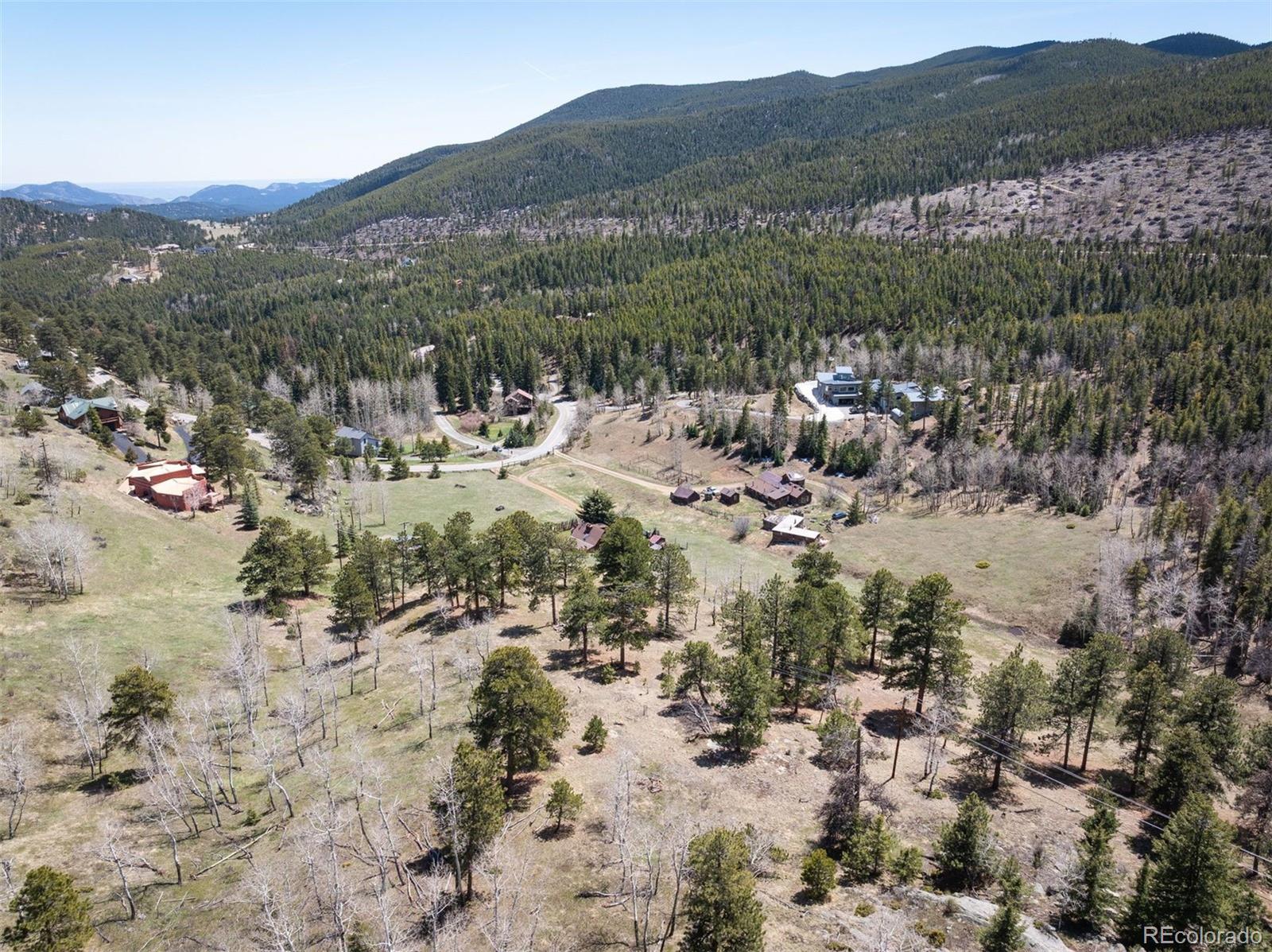 Pine Valley Road Evergreen, CO 80439 - Photo 22 of 30 a view of a forest with mountains in the background