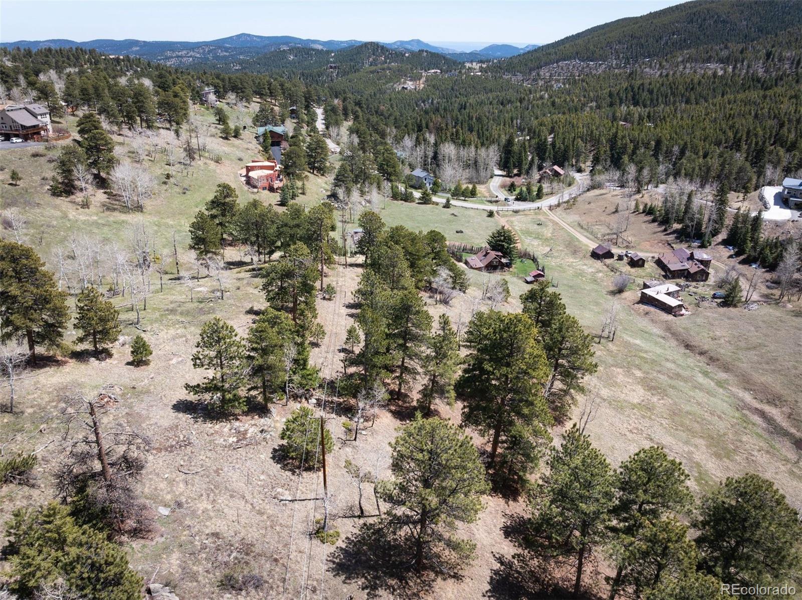 Pine Valley Road Evergreen, CO 80439 - Photo 23 of 30 a view of a forest with a lake