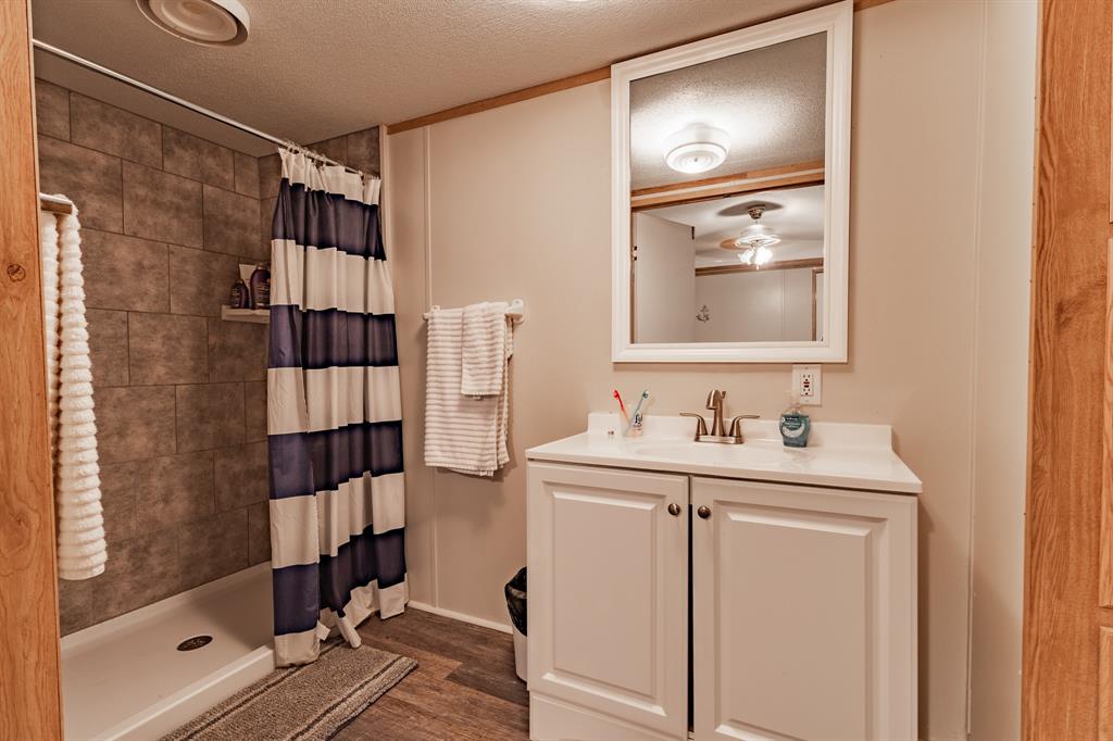 4705 Fox Hollow Road, Unit 30 Graham, TX 76450 - Photo 12 of 31 a bathroom with a sink and a mirror