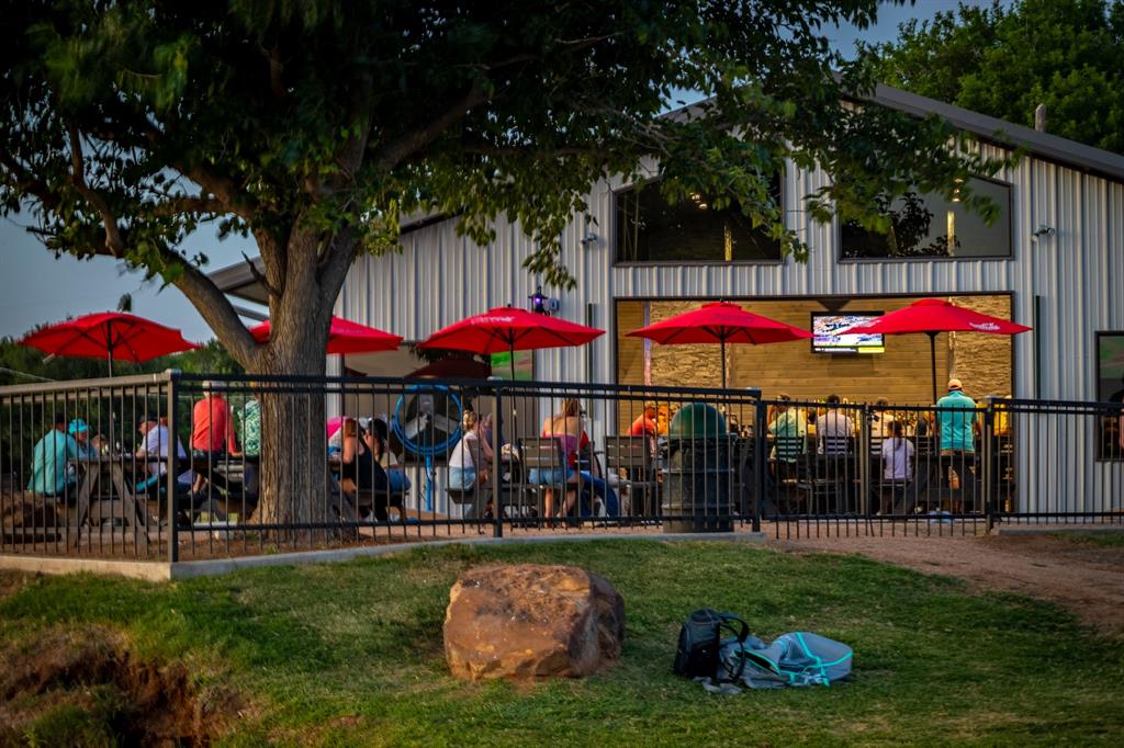 4705 Fox Hollow Road, Unit 30 Graham, TX 76450 - Photo 23 of 31 a group of people sitting in front of a house and a yard