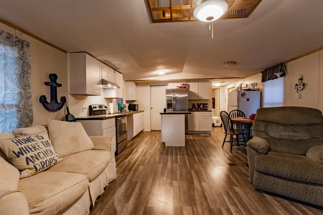 a living room with furniture and kitchen view