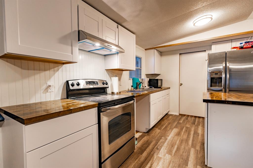 4705 Fox Hollow Road, Unit 30 Graham, TX 76450 - Photo 6 of 31 a kitchen with stainless steel appliances granite countertop a sink a stove and a refrigerator