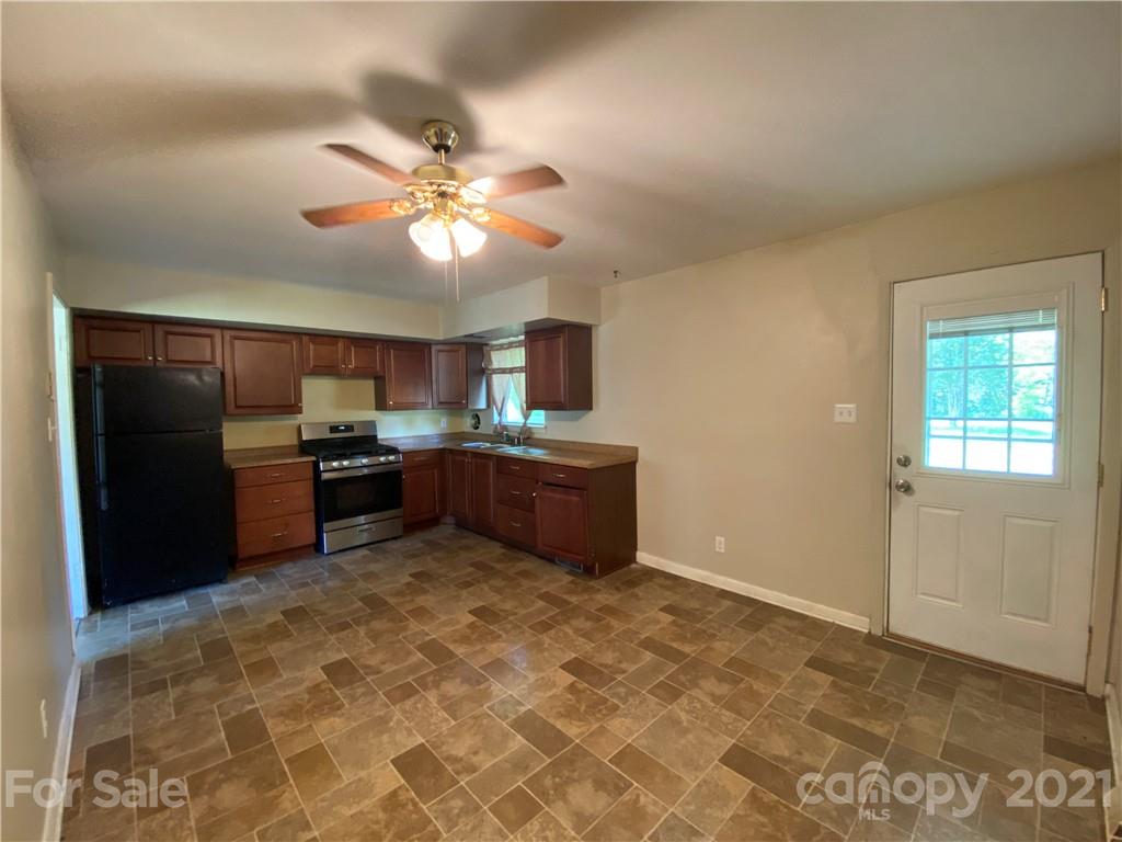 612 Jennings Road Rock Hill, SC 29730 - Photo 16 of 27 a kitchen with kitchen island granite countertop a refrigerator and a sink