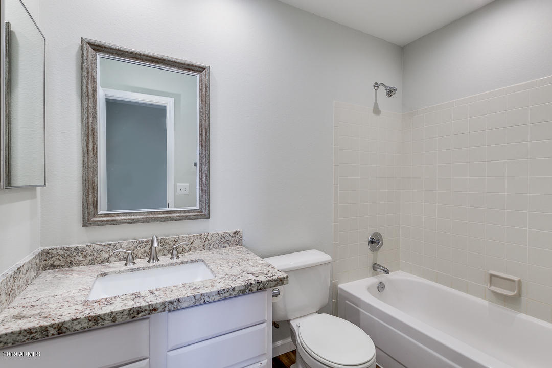 6149 Casper Road Mesa, AZ 85205 - Photo 14 of 21 a bathroom with a granite countertop sink and a mirror