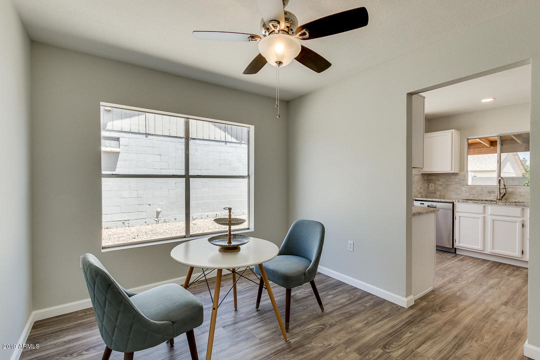6149 Casper Road Mesa, AZ 85205 - Photo 6 of 21 a view of a dining room with furniture window and wooden floor