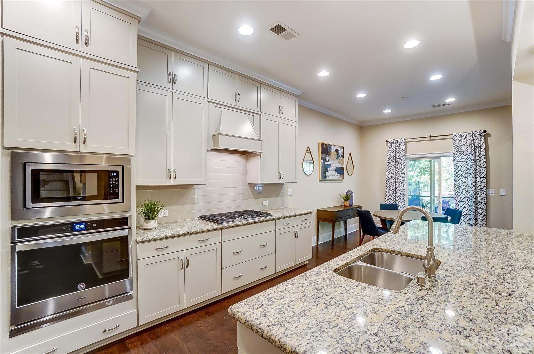 1494 Afton Way Fort Mill, SC 29708 - Photo 11 of 47 a kitchen with stainless steel appliances granite countertop a stove sink and cabinets