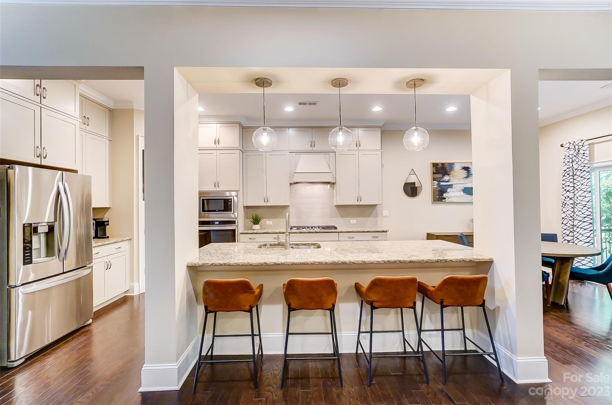 1494 Afton Way Fort Mill, SC 29708 - Photo 12 of 47 a kitchen with stainless steel appliances granite countertop a table chairs and wooden floor