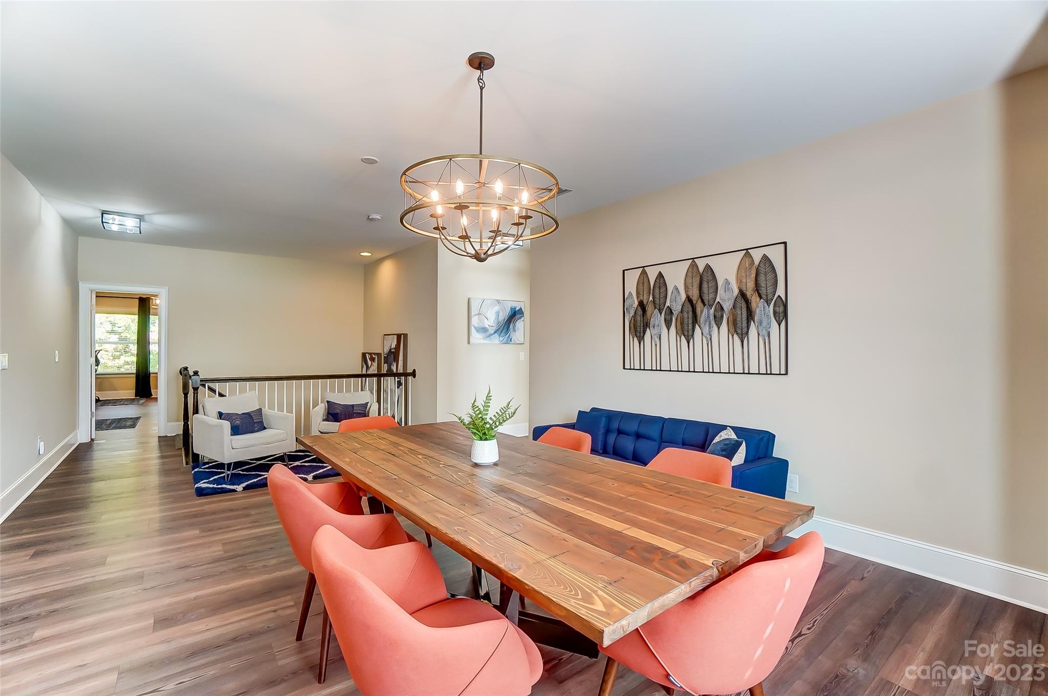 1494 Afton Way Fort Mill, SC 29708 - Photo 26 of 47 a dining room with wooden floor a chandelier a wooden table and chairs