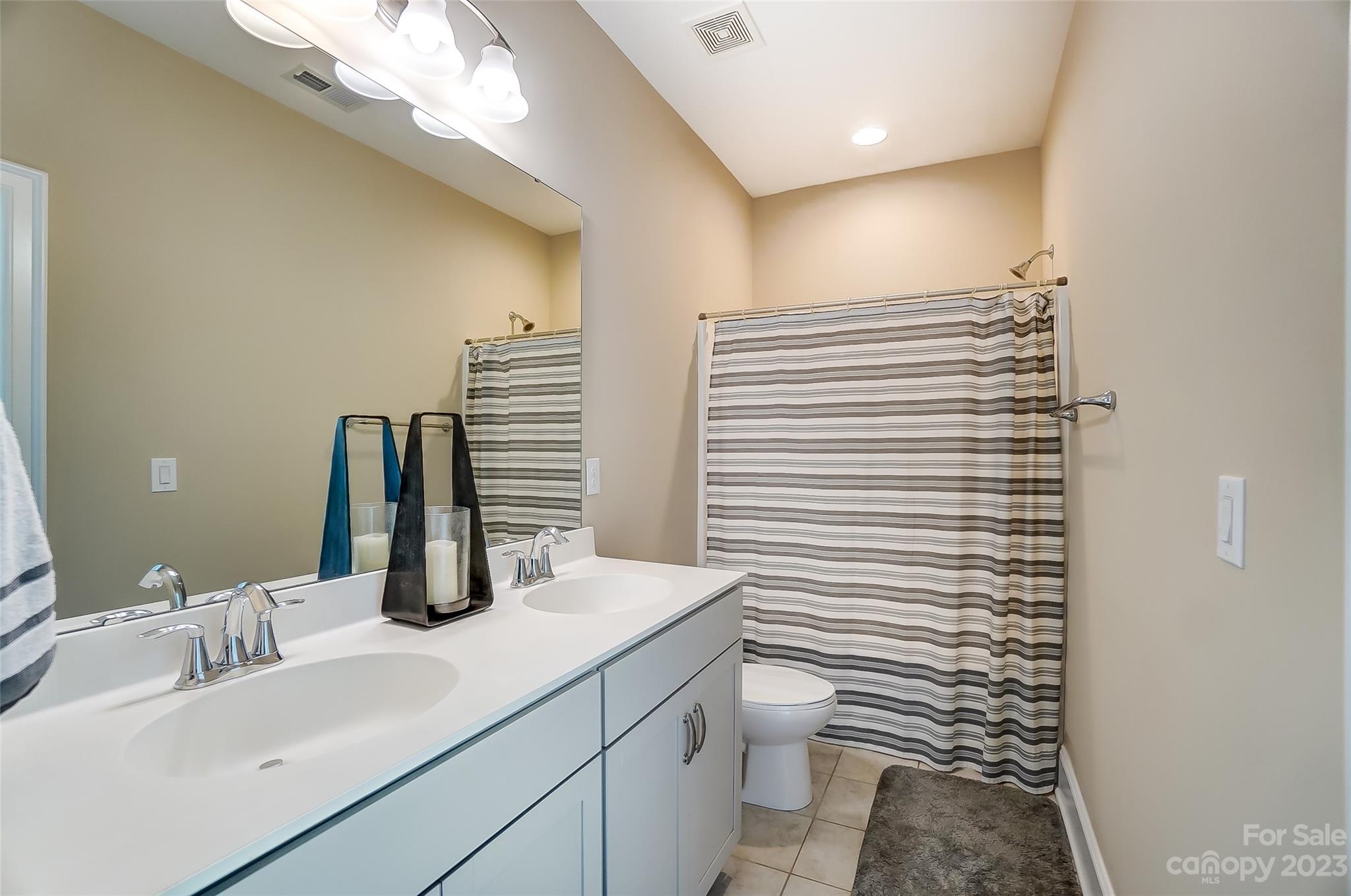 1494 Afton Way Fort Mill, SC 29708 - Photo 29 of 47 a bathroom with a toilet a sink and a mirror