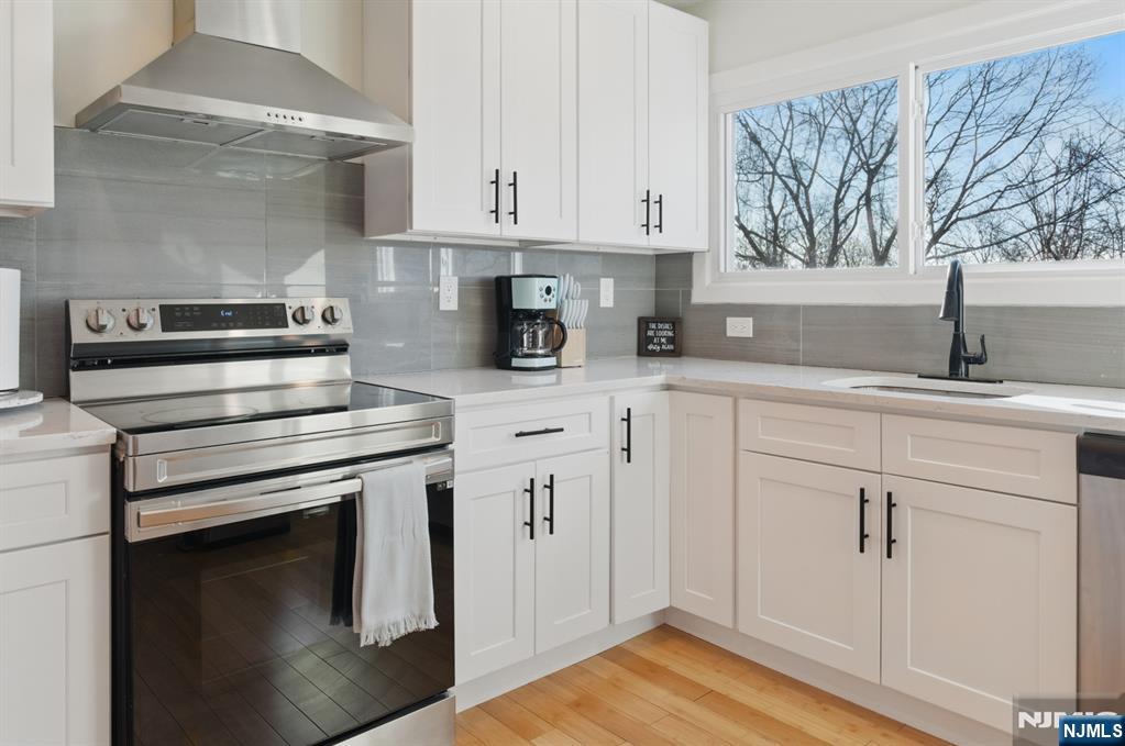 21 Skyview Road Ringwood, NJ 07456 - Photo 26 of 49 a kitchen with white cabinets and appliances