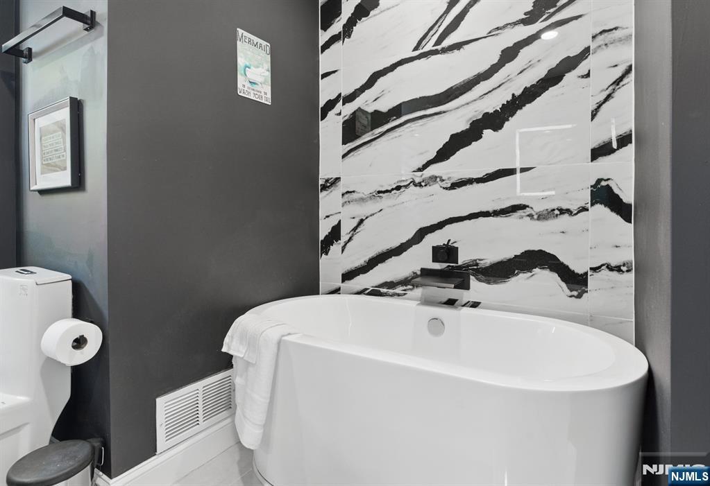 21 Skyview Road Ringwood, NJ 07456 - Photo 31 of 49 a bathroom with a sink and mirror with toilet