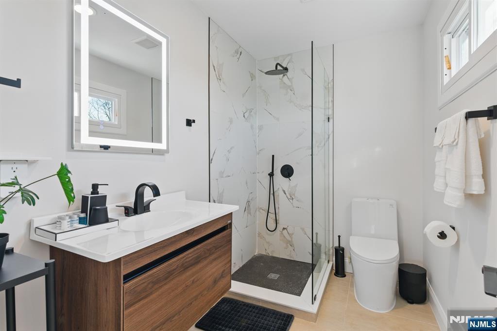 21 Skyview Road Ringwood, NJ 07456 - Photo 35 of 49 a bathroom with a sink a toilet and shower