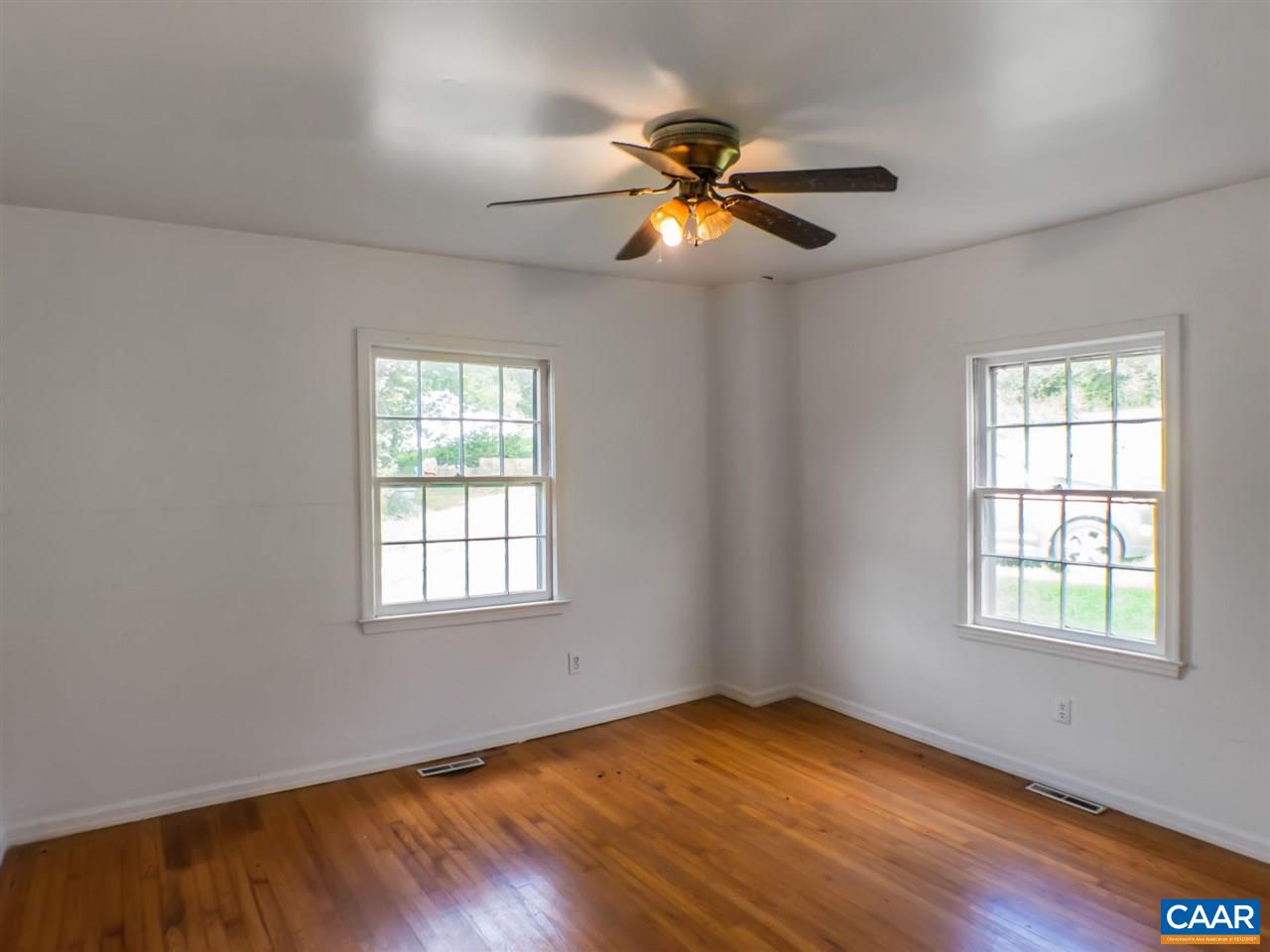 7595 Esmont Road Esmont, VA 22937 - Photo 12 of 30 a view of an empty room with wooden floor and a window