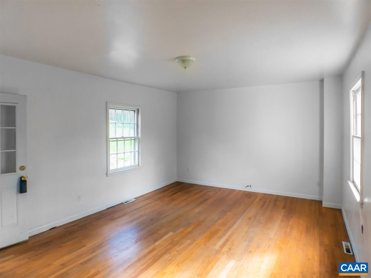 7595 Esmont Road Esmont, VA 22937 - Photo 13 of 30 a view of empty room with wooden floor and fan
