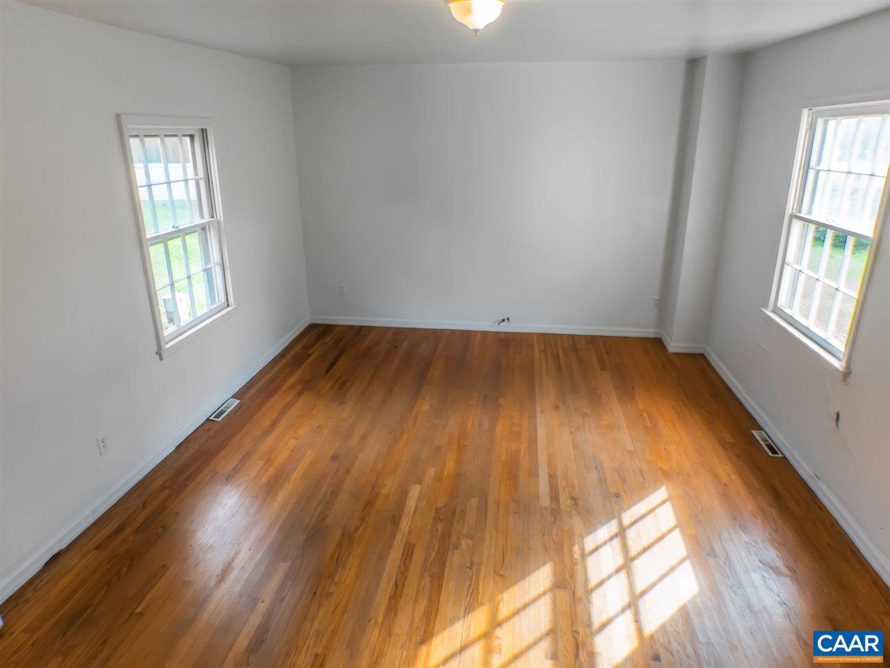 7595 Esmont Road Esmont, VA 22937 - Photo 14 of 30 an empty room with wooden floor and windows
