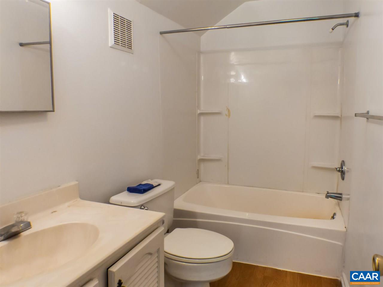 7595 Esmont Road Esmont, VA 22937 - Photo 20 of 30 a bath room with a toilet sink and a bath tub