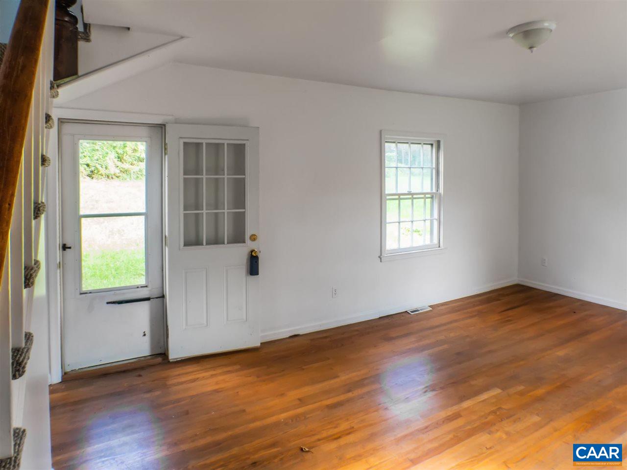 7595 Esmont Road Esmont, VA 22937 - Photo 5 of 30 an empty room with wooden floor and windows