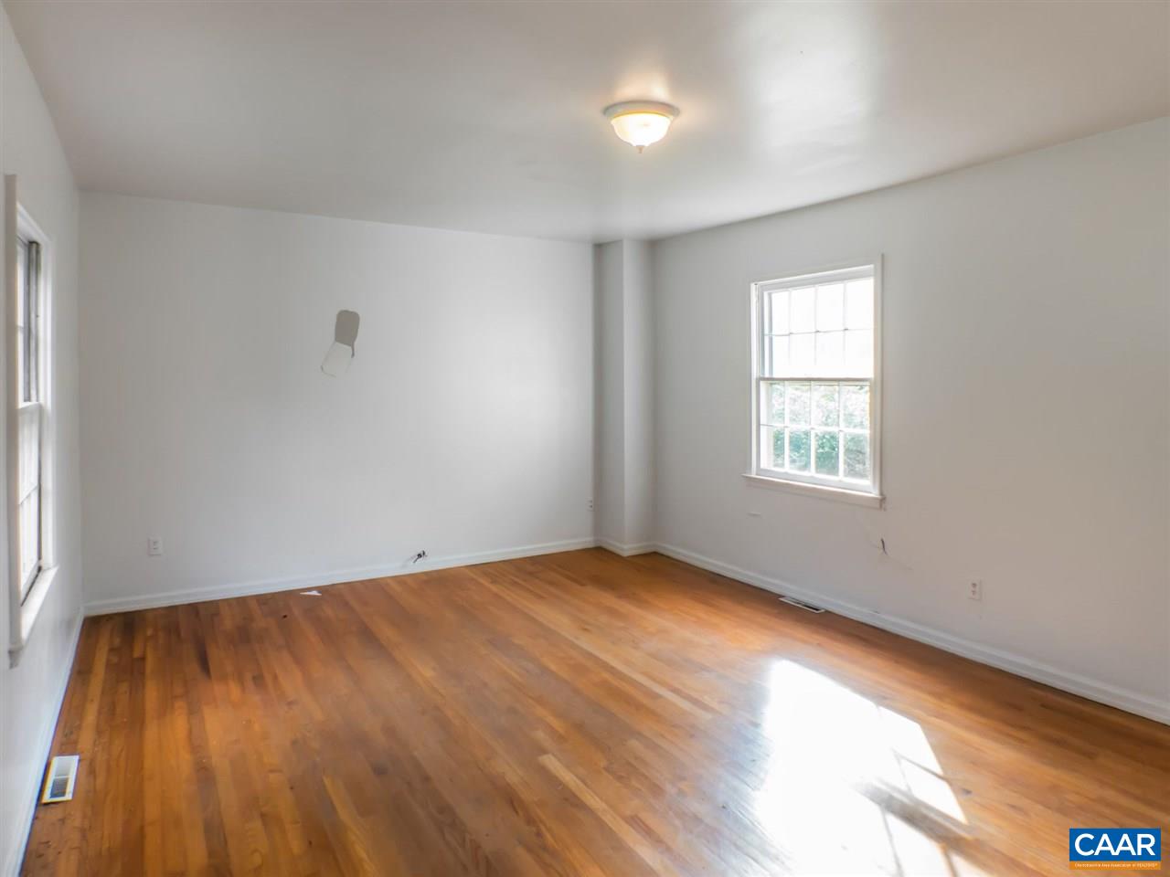 7595 Esmont Road Esmont, VA 22937 - Photo 6 of 30 an empty room with wooden floor and windows