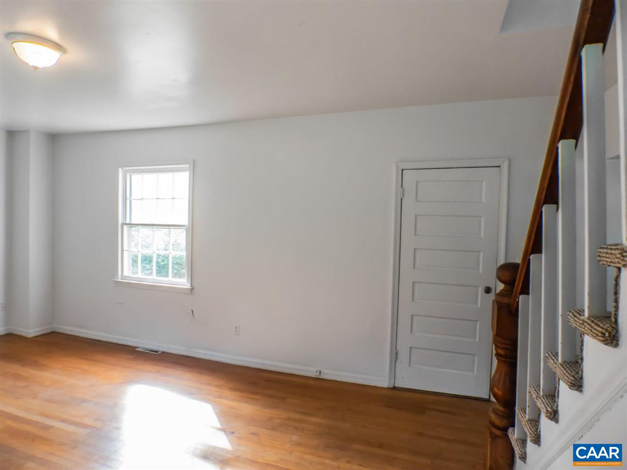 7595 Esmont Road Esmont, VA 22937 - Photo 7 of 30 an empty room with wooden floor and windows
